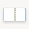 light blue notebook open to lined pages