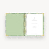 open notebook with green liner, gold binding, day designer title page