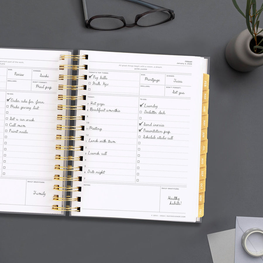 Day Designer 2026 mini daily planner: charcoal bookcloth opened with writing on it