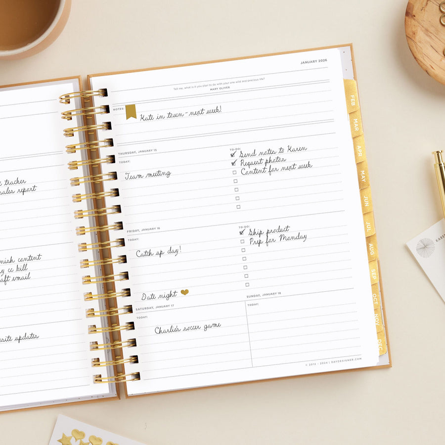 Day Designer 2026 weekly planner: caramel latte pebble texture opened with writing on it