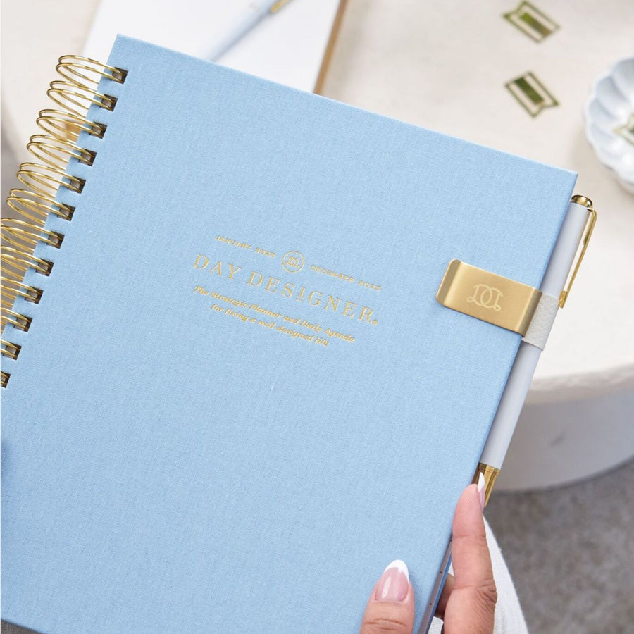 light blue day designer planner with pen loop clip and white pen