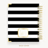 Wire-bound notebook with black and white striped cover and gold accents on a white background