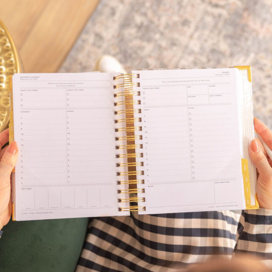 mini daily planner, open book to show layout, gingham pattern, hands, gold table