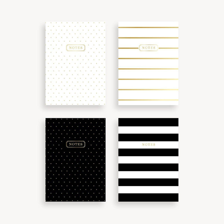 Four notepads with different design patterns on a white background
