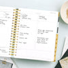 Day Designer 2023-24 Daily Planner Black Stripe opened with writing on it
