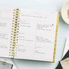 Day Designer 2023-24 Weekly Planner Black Stripe opened with writing on it
