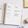 Day Designer 2023-24 Daily Planner Blurred Spring opened with writing on it