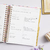 Day Designer 2023-24 Weekly Planner Blurred Spring opened with writing on it