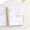 Day Designer 2023-24 Mini Daily Planner Sage Bookcloth opened with writing on it