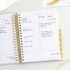 Day Designer 2023-24 Daily Planner Sage Bookcloth opened with writing on it