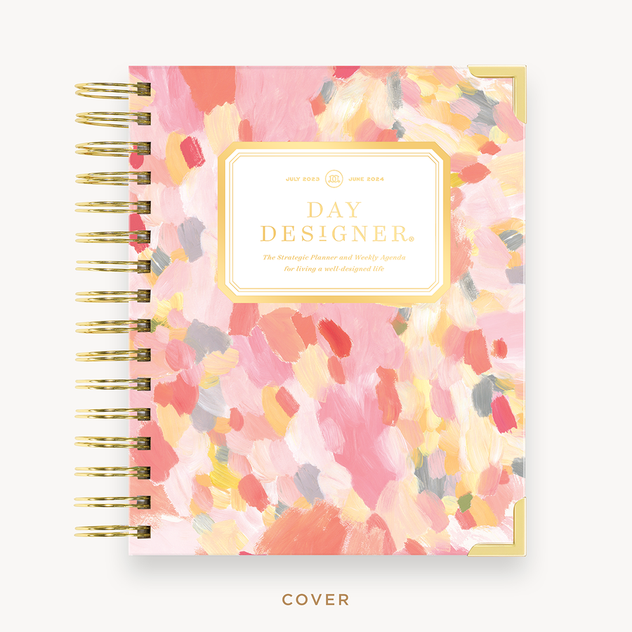 Day Designer's 2023 Weekly Mini Planner with Sunset hard cover and gold spiral binding.