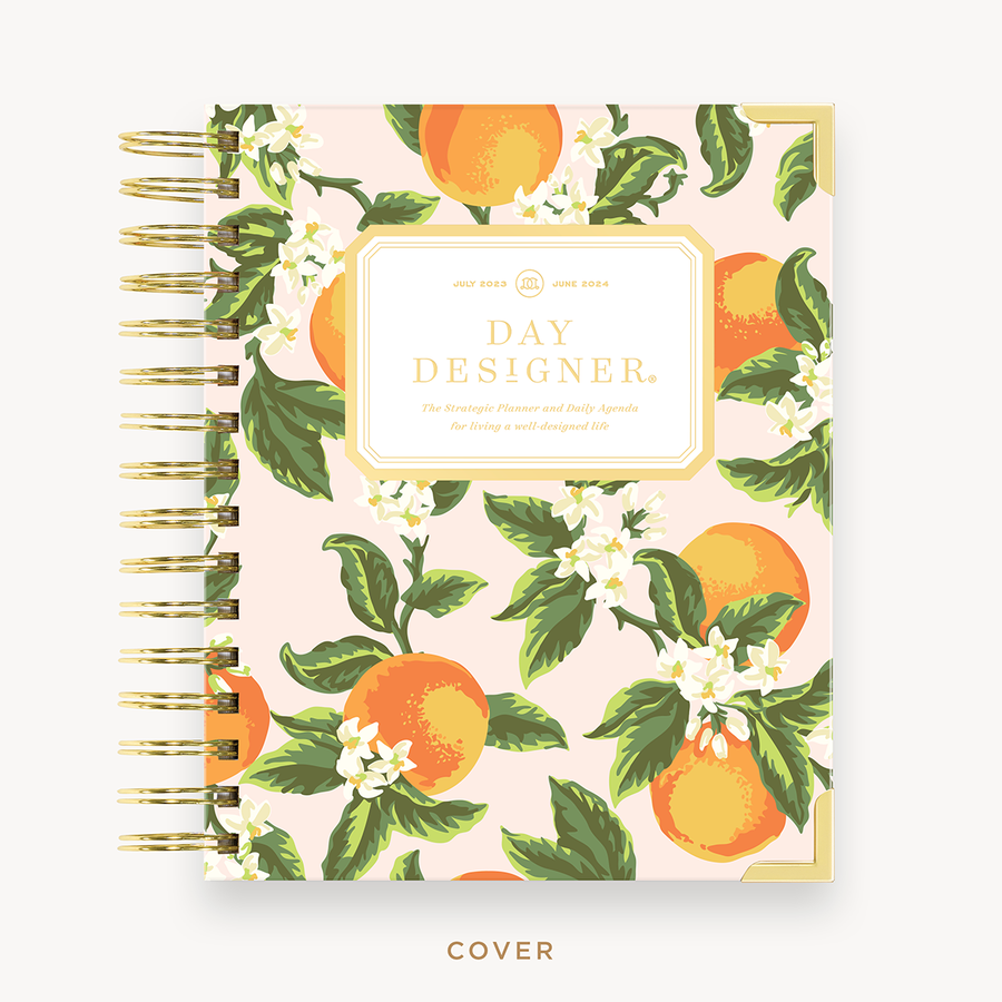 Day Designer's 2023-24 Daily Mini Planner with Orange Blossom hard cover and gold spiral binding.