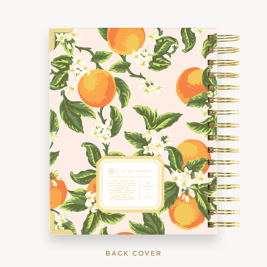 Day Designer's 2023-24 Daily Mini Planner with Orange Blossom back cover and gold spiral binding.