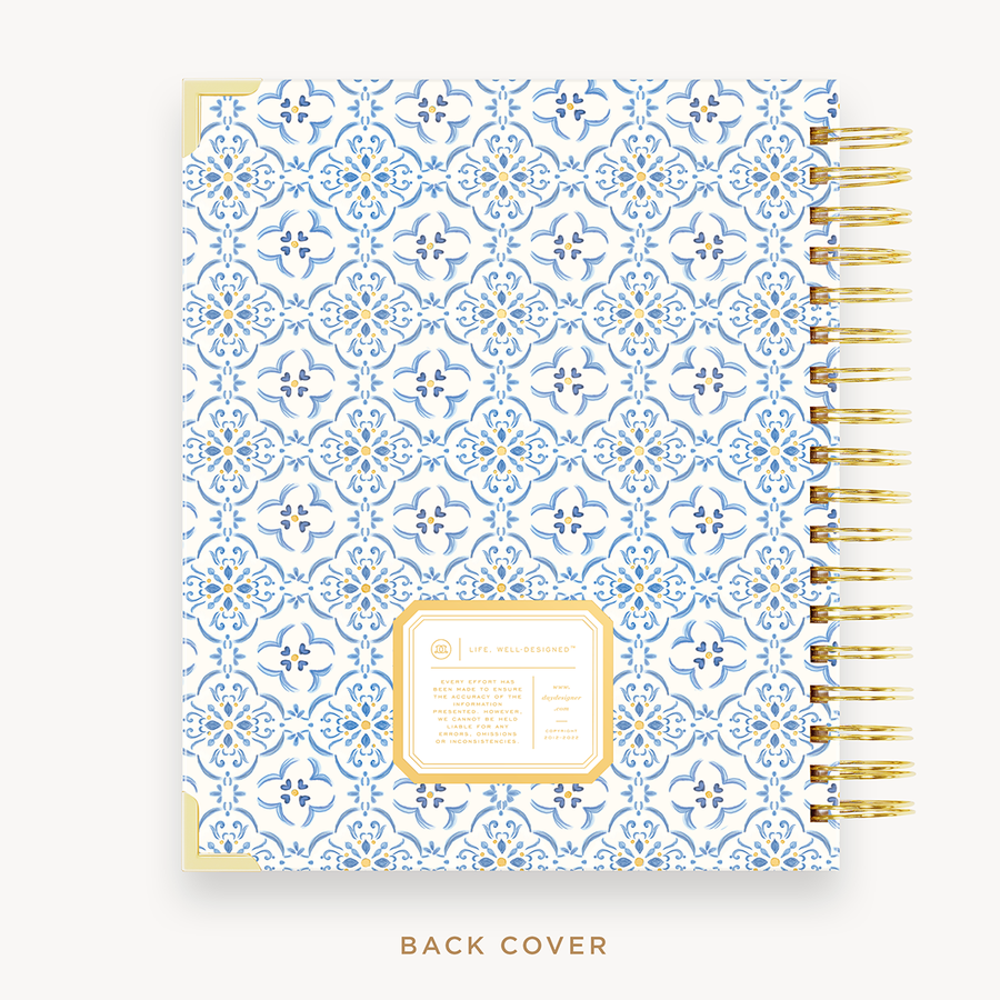 Day Designer's 2023 Weekly Planner with Casa Bella back cover and gold spiral binding.