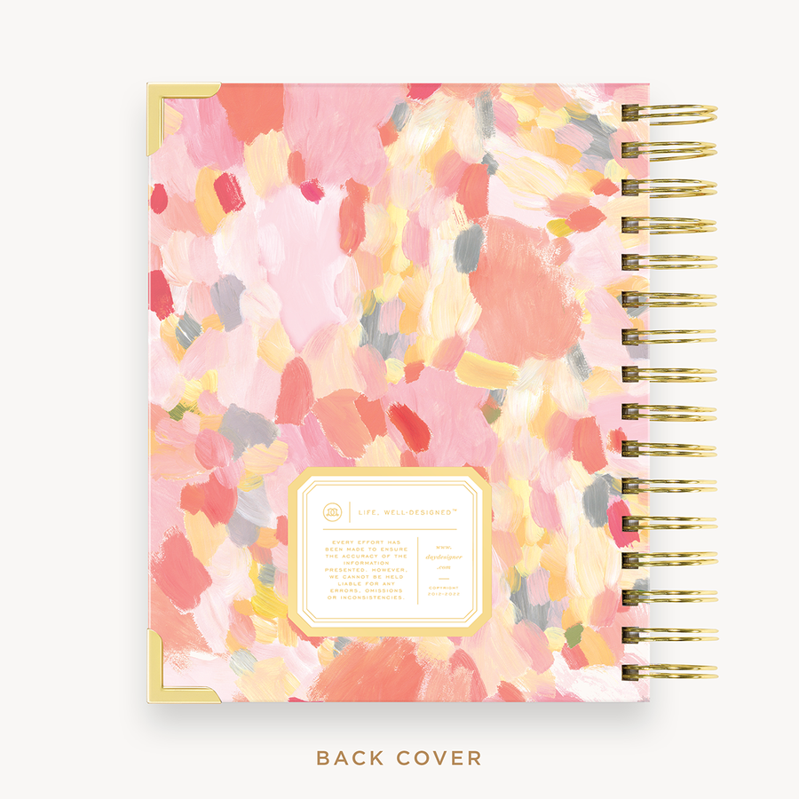 Day Designer's 2023 Daily Mini Planner with Sunset back cover and gold spiral binding.