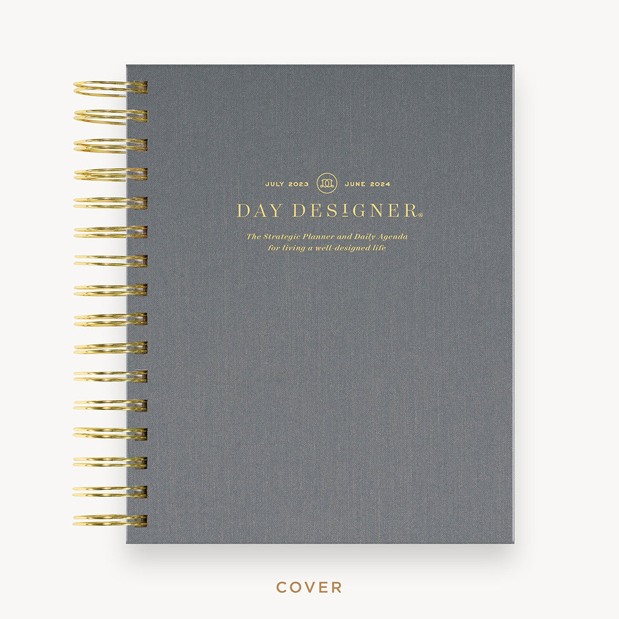 Day Designer's 2023 Daily Mini Planner with Charcoal Bookcloth hard cover and gold spiral binding.