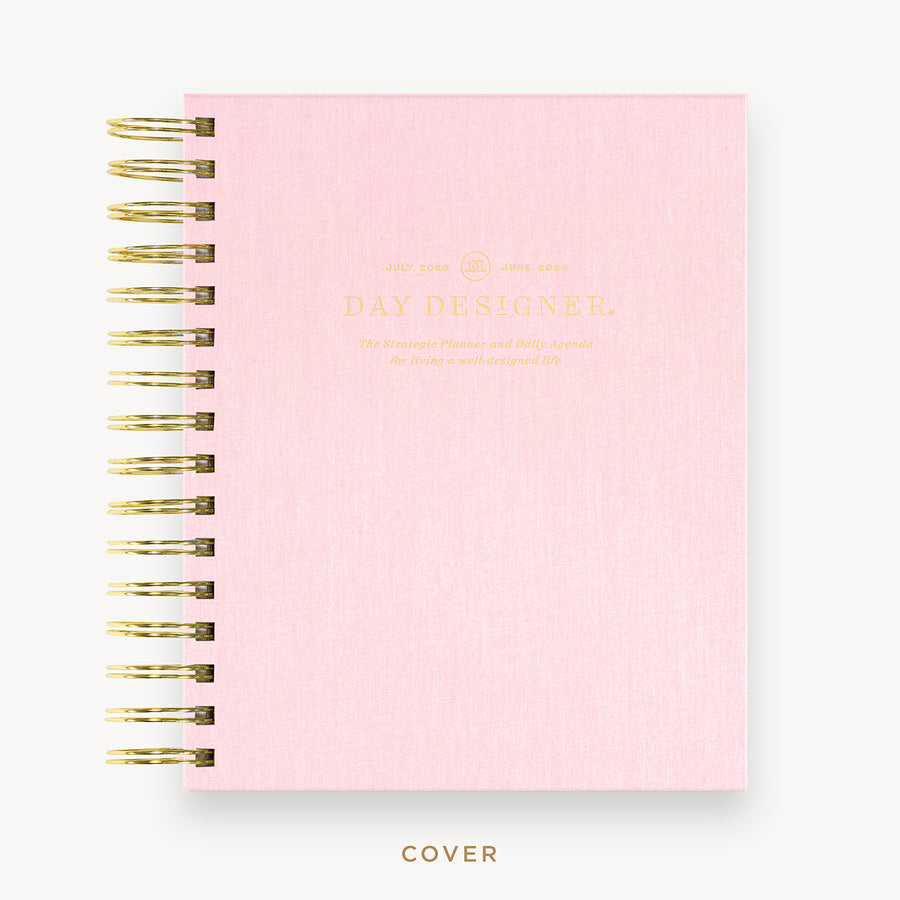 Day Designer's 2023 Daily Mini Planner with Peony Bookcloth hard cover and gold spiral binding.