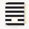 Day Designer's 2023 Daily Planner with Black Stripe back cover and gold spiral binding.