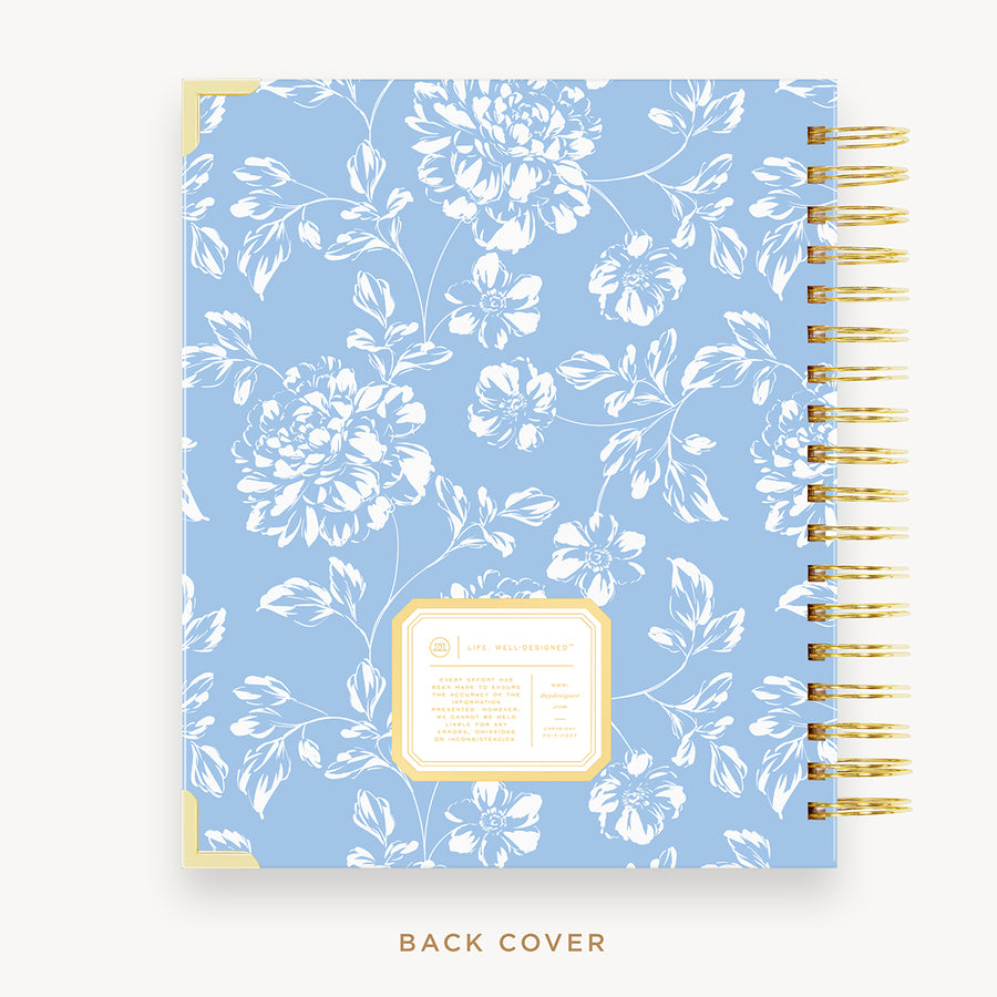 Day Designer's 2023 Daily Planner with Annabel back cover and gold spiral binding.