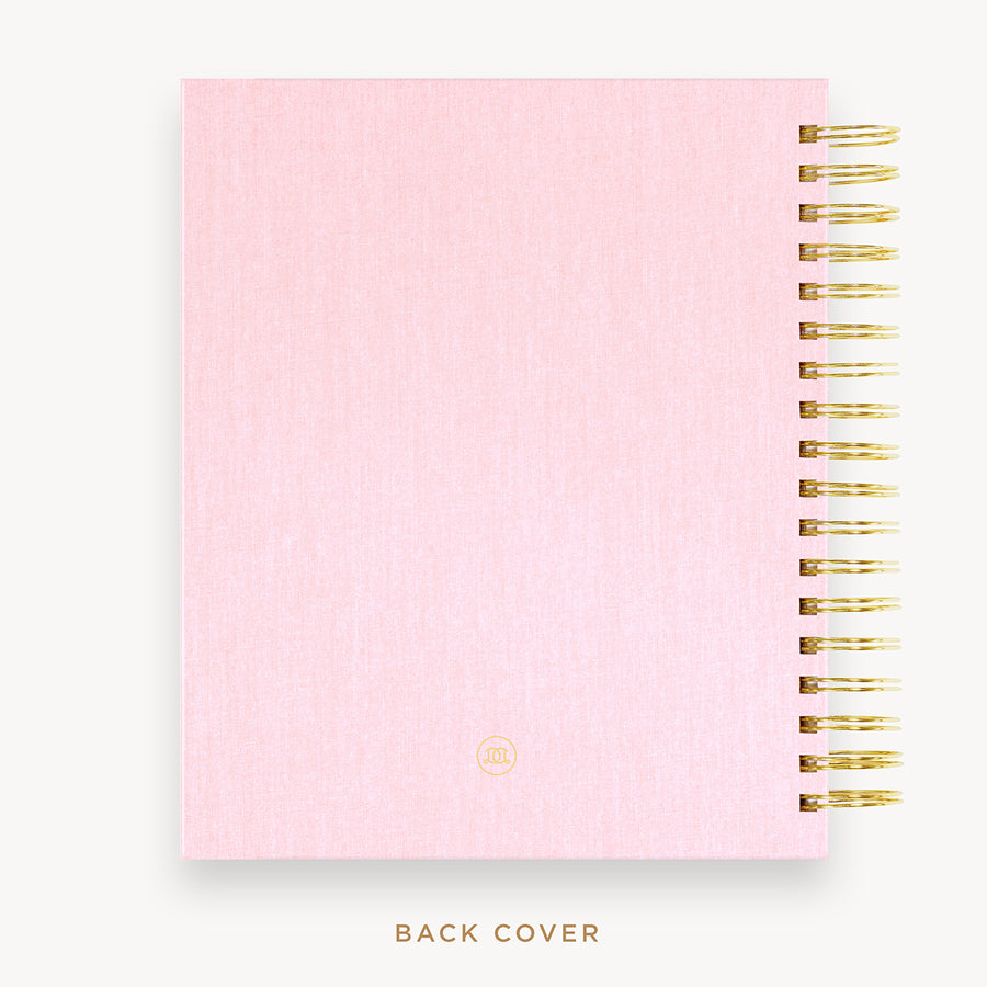 Day Designer's 2023 Daily Planner with Peony Bookcloth back cover and gold spiral binding.